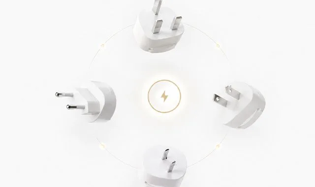 International plug adapters arranged around a power symbol